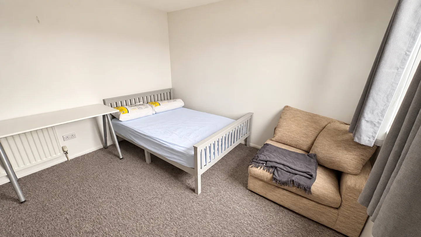 Bedroom with an armchair and desk